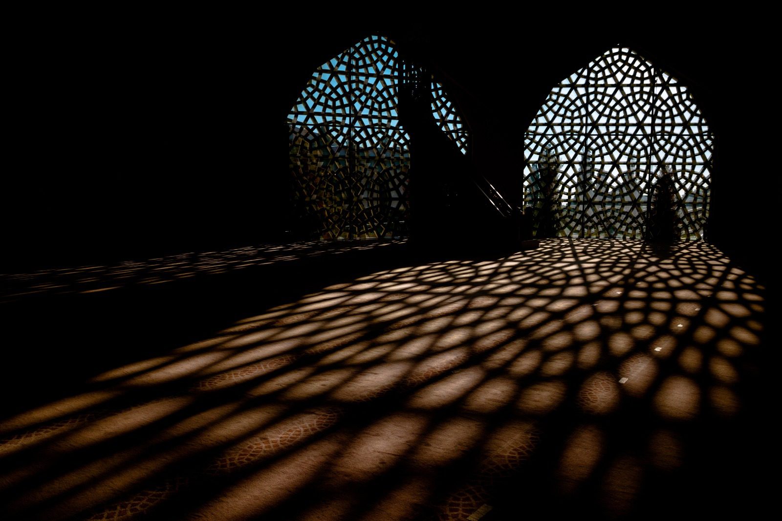 A room with many windows and shadows on the floor