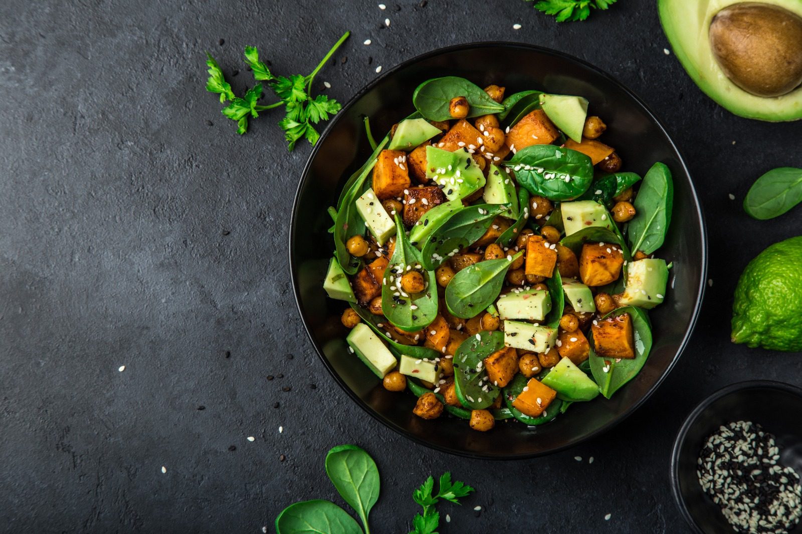 A bowl of food with vegetables and herbs.