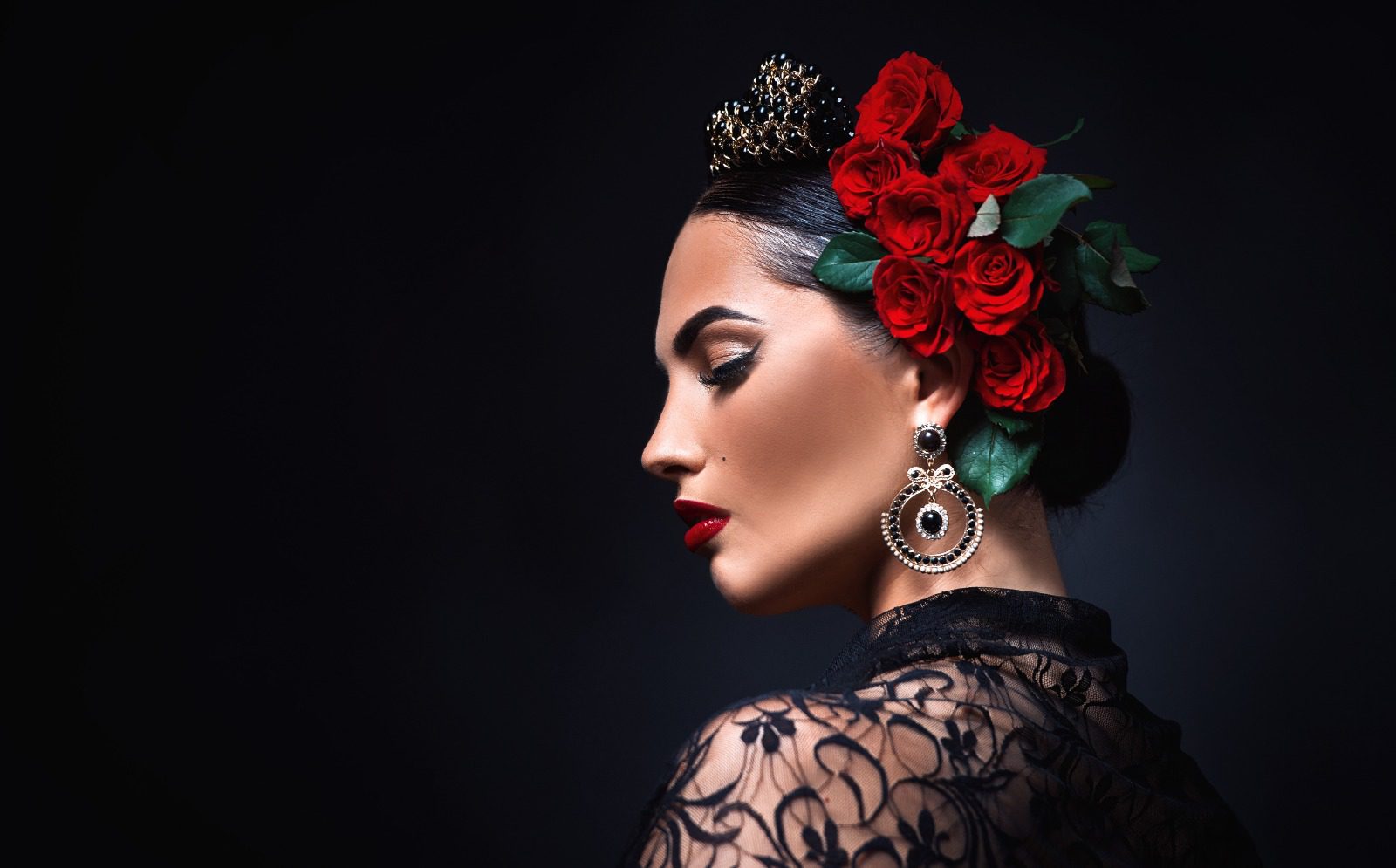 A woman with red roses in her hair.