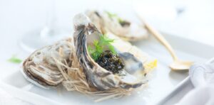 A close up of an opened oyster on a plate