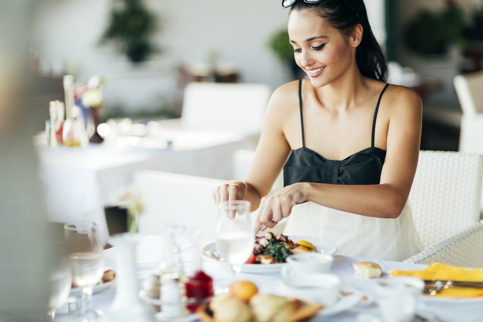 A woman sitting at the table with food in front of her.