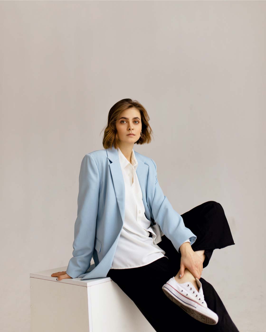 A woman sitting on top of a white table.