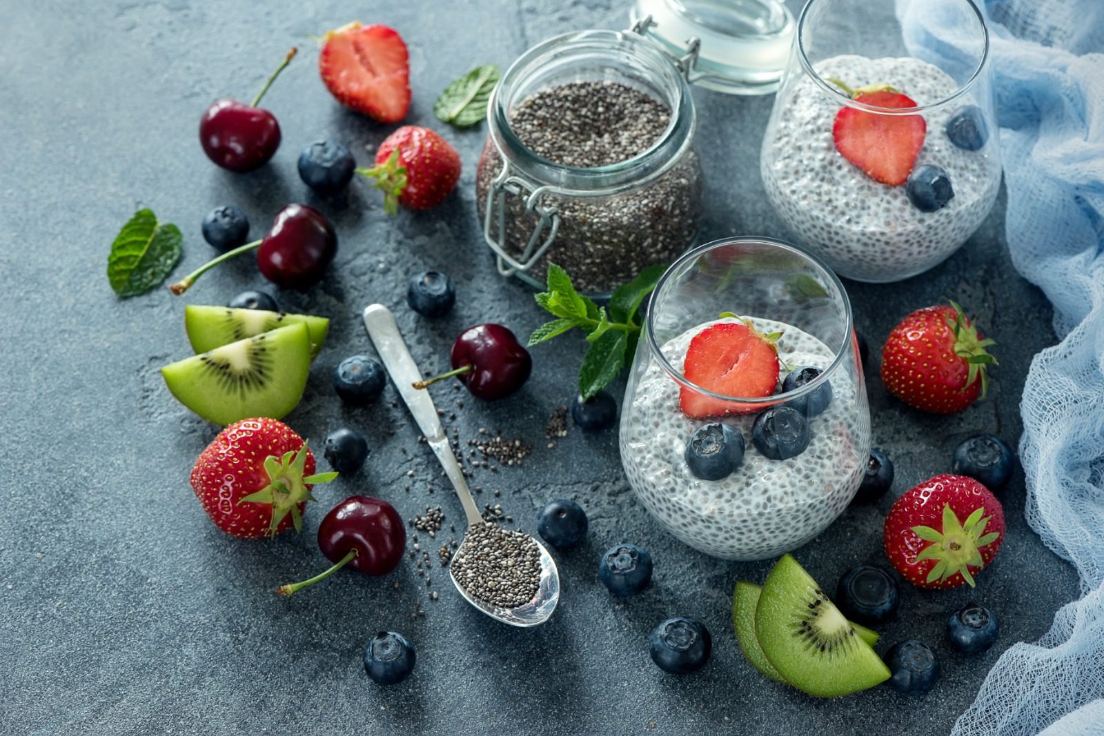 A table topped with fruit and chia seeds.