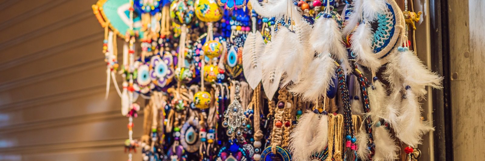 A bunch of colorful feathers hanging from the ceiling