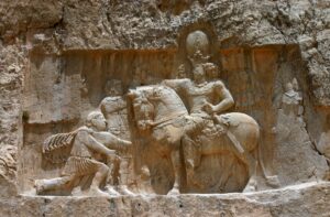 A stone carving of a man on horseback and another person.