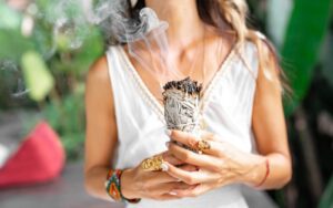 A woman holding a bundle of sticks in her hands.