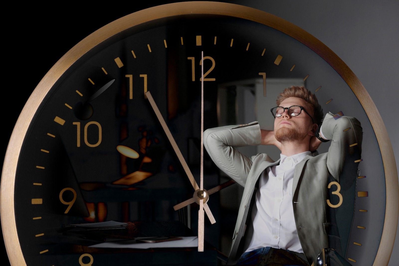 A man sitting in front of an analog clock.